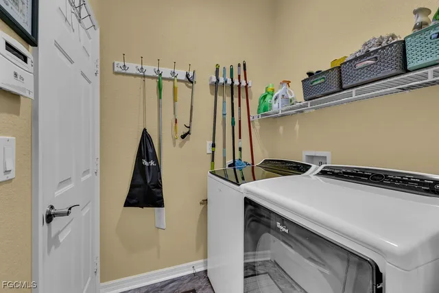 an aerial view of a house with a yard and a large tree