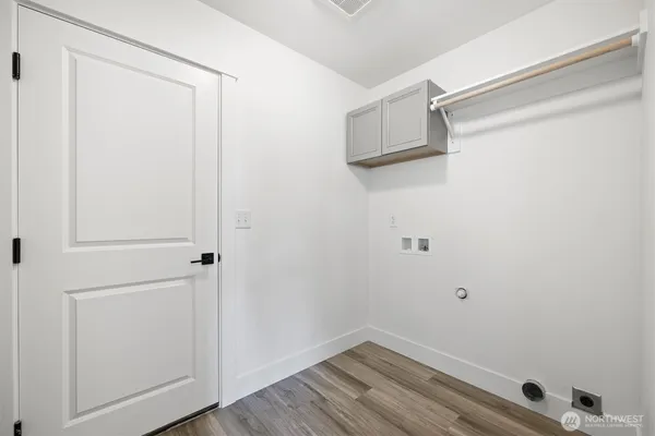 a view of a room with wooden floor