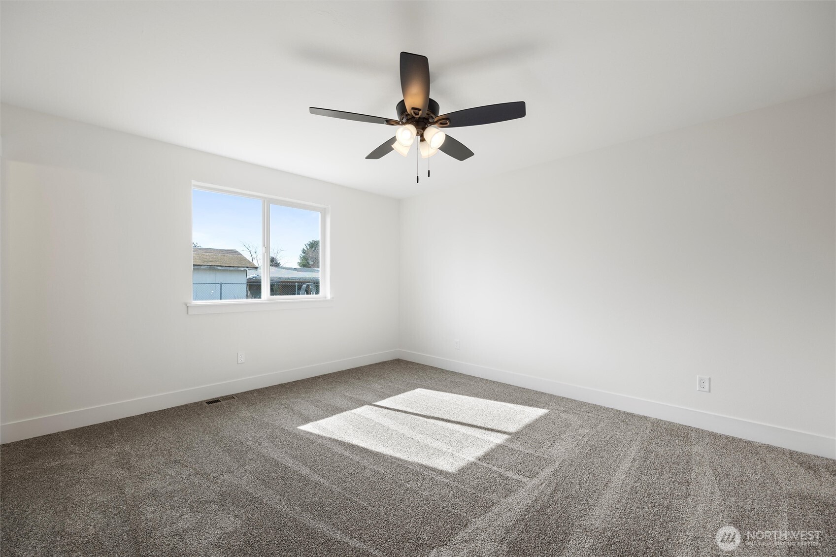 653 East Franklin Street Connell, WA 99326 - Photo 13 of 26 an empty room with windows and fan