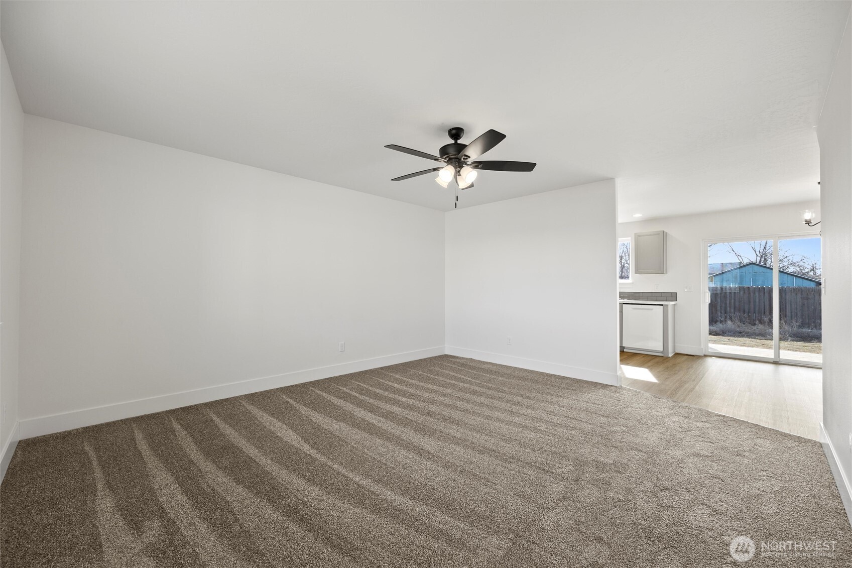653 East Franklin Street Connell, WA 99326 - Photo 3 of 26 a view of empty room with wooden floor and ceiling fan