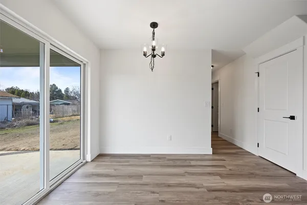 a view of a room with wooden floor and windows