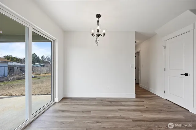 a view of a room with wooden floor and windows