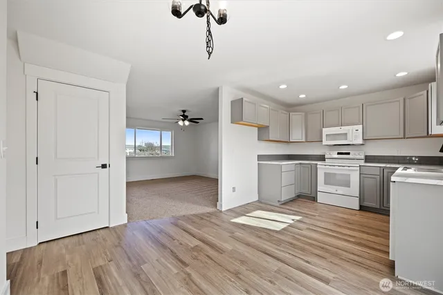 a kitchen with a refrigerator and white cabinets