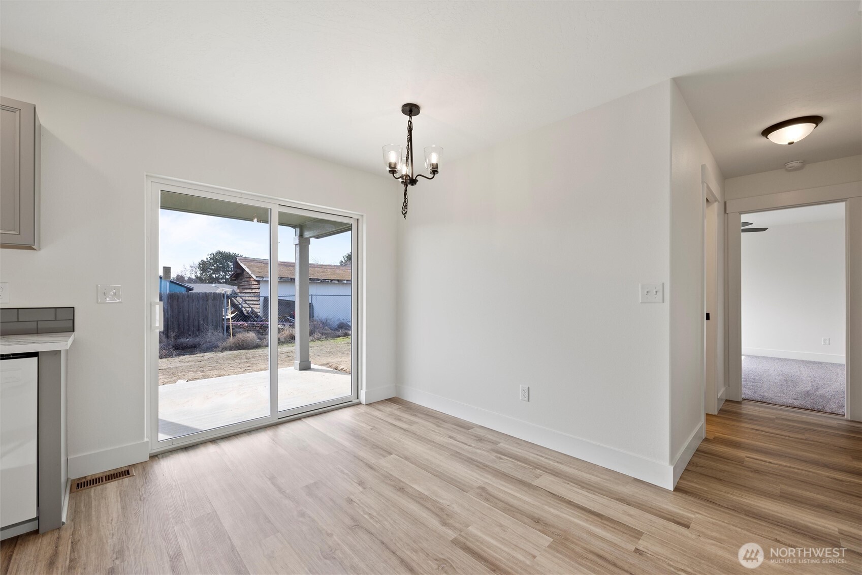 653 East Franklin Street Connell, WA 99326 - Photo 7 of 26 a view of a big room with wooden floor and windows