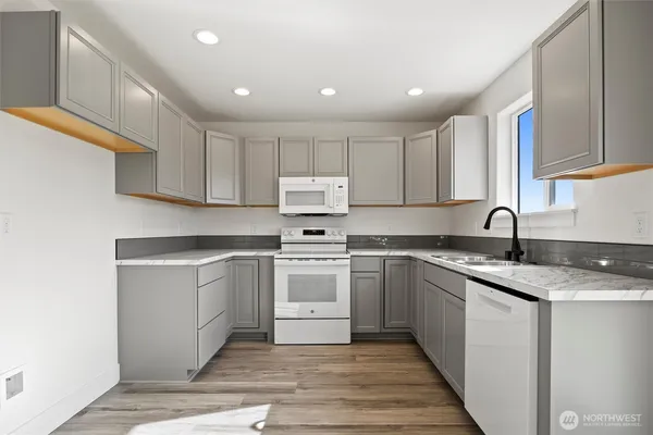 a kitchen with a sink cabinets and stainless steel appliances