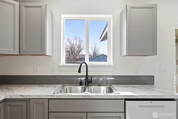 a close view of sink and cabinets