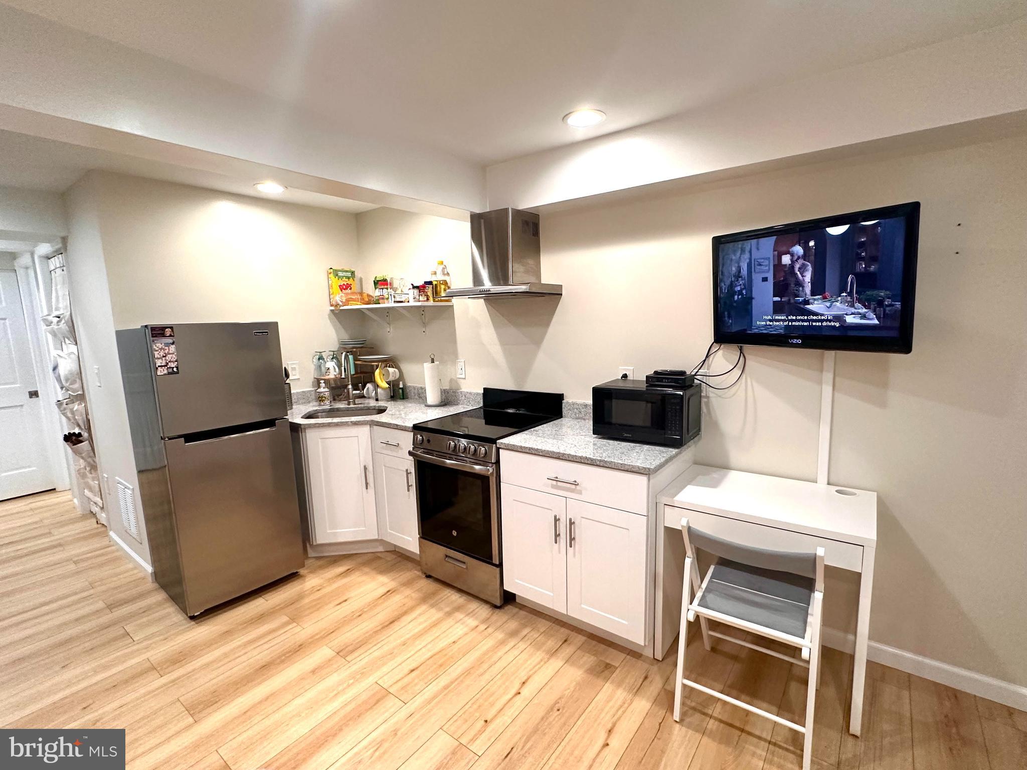 8301 Windfall Road Springfield, VA 22153 - Photo 27 of 27 a kitchen with a refrigerator and a stove top oven