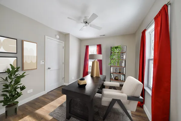 a living room with furniture and a potted plant
