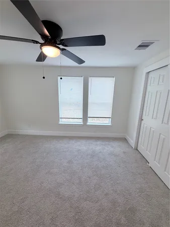 a view of empty room with ceiling fan