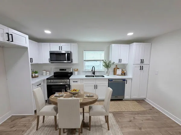 a kitchen with refrigerator stove microwave and cabinets