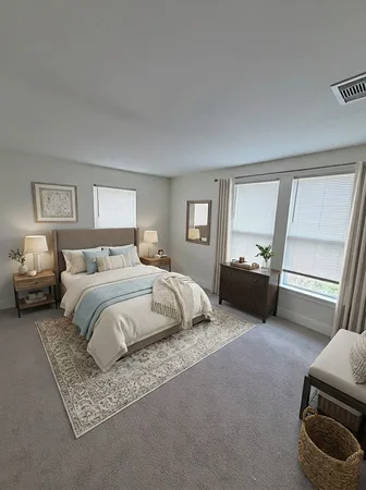 a spacious bedroom with a bed and wooden floor