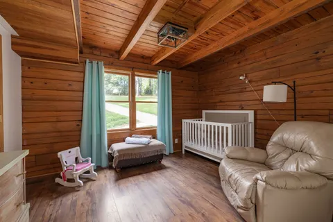 a bedroom with a bed and dresser with mirror