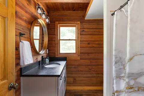 a view of a room with a window and wooden floor