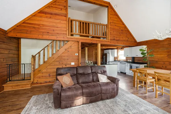 a living room with furniture and a wooden floor