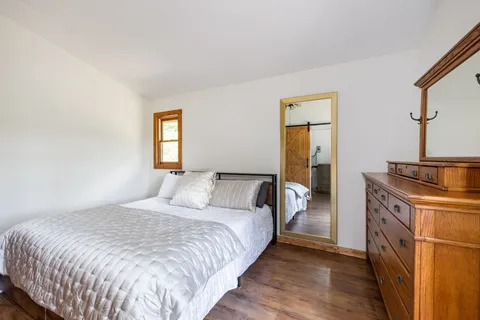 a bedroom with a bed and window