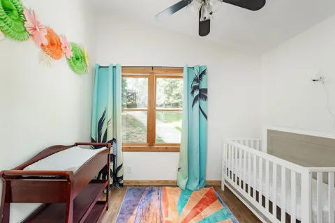 a view of balcony with wooden floor and fence and floor to ceiling window