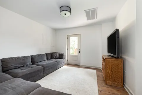 a view of a house with a small yard next to a road