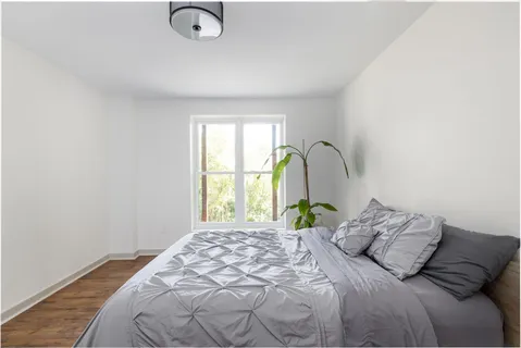 an aerial view of a house with swimming pool of a yard