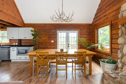 a kitchen with stainless steel appliances granite countertop a sink a stove and a wooden floors