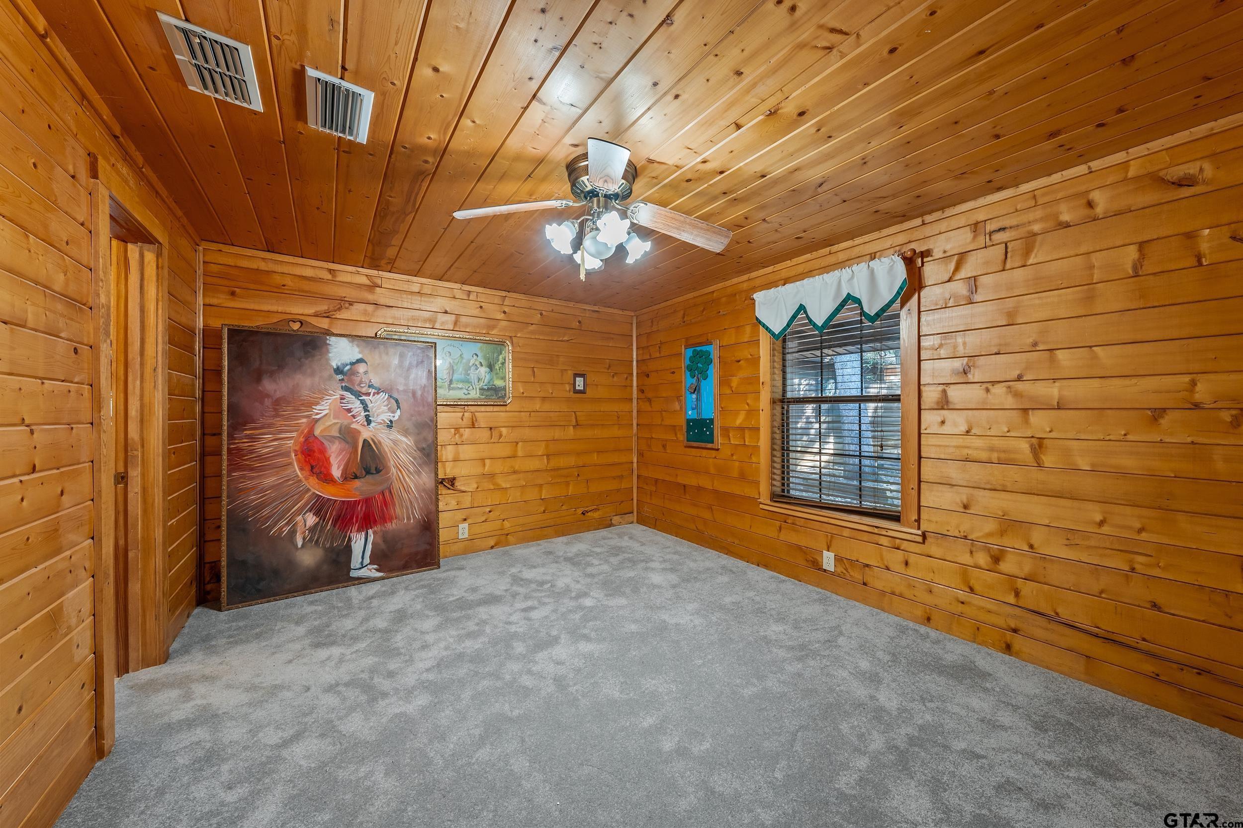 325 Laurel Lane Holly Lake Ranch, TX 75765 - Photo 17 of 34 a view of an empty room with window and chandelier