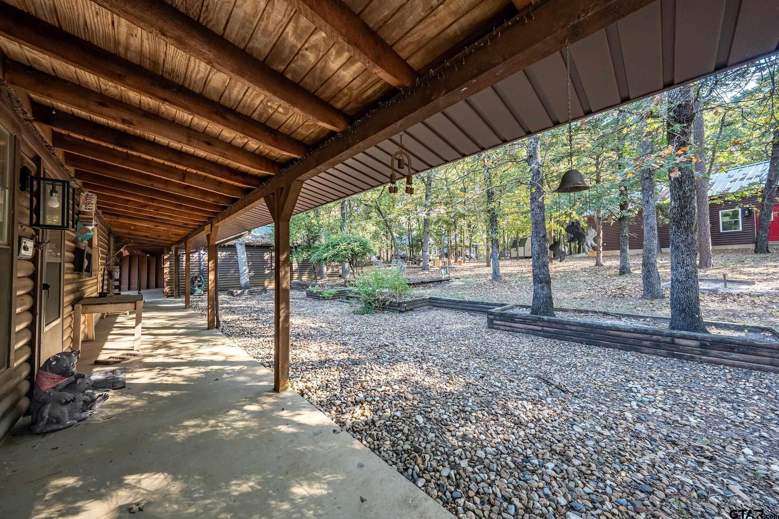 325 Laurel Lane Holly Lake Ranch, TX 75765 - Photo 21 of 34 a view of a backyard with wooden floor
