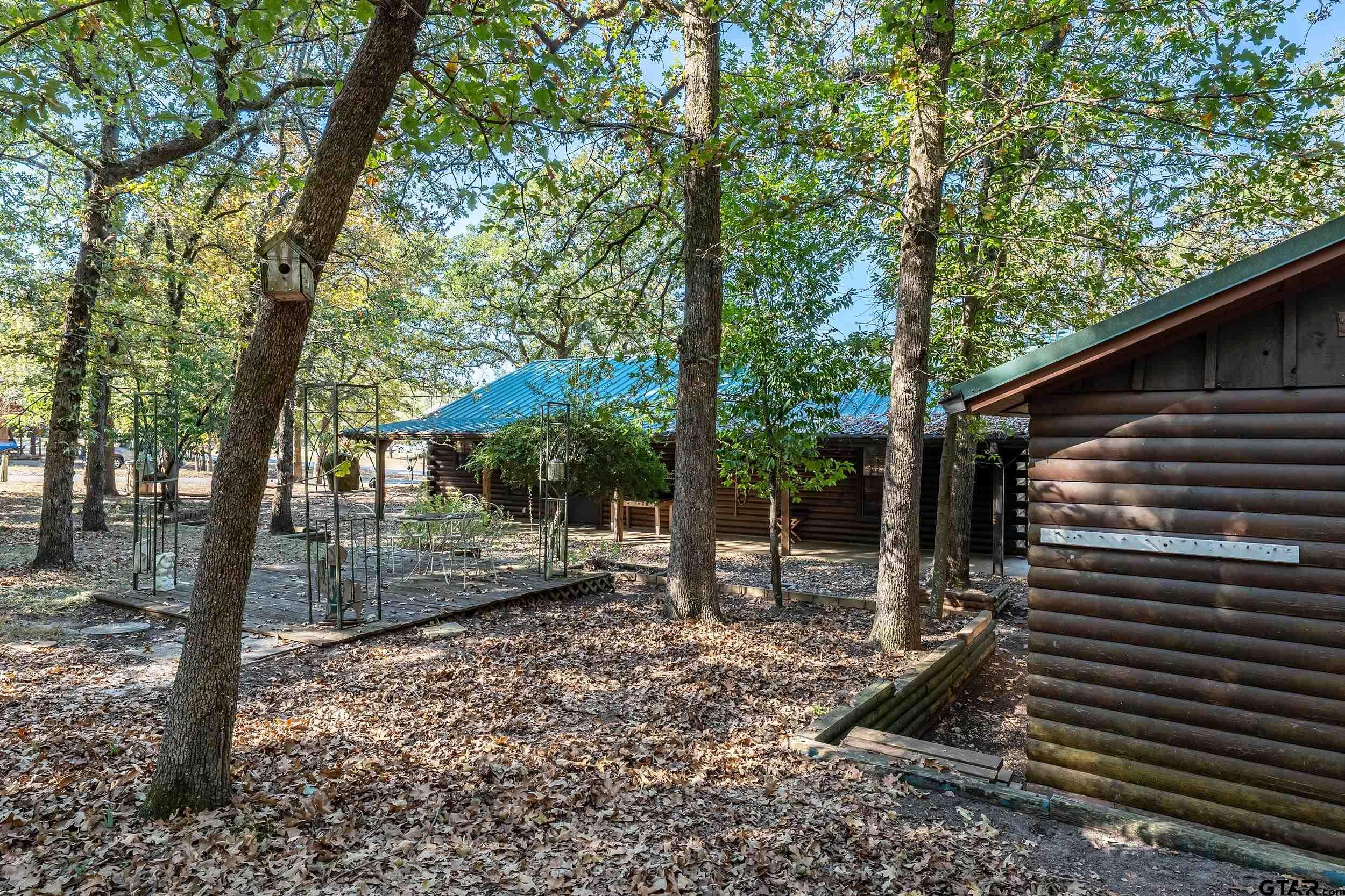 325 Laurel Lane Holly Lake Ranch, TX 75765 - Photo 24 of 34 a backyard of a house with lots of green space