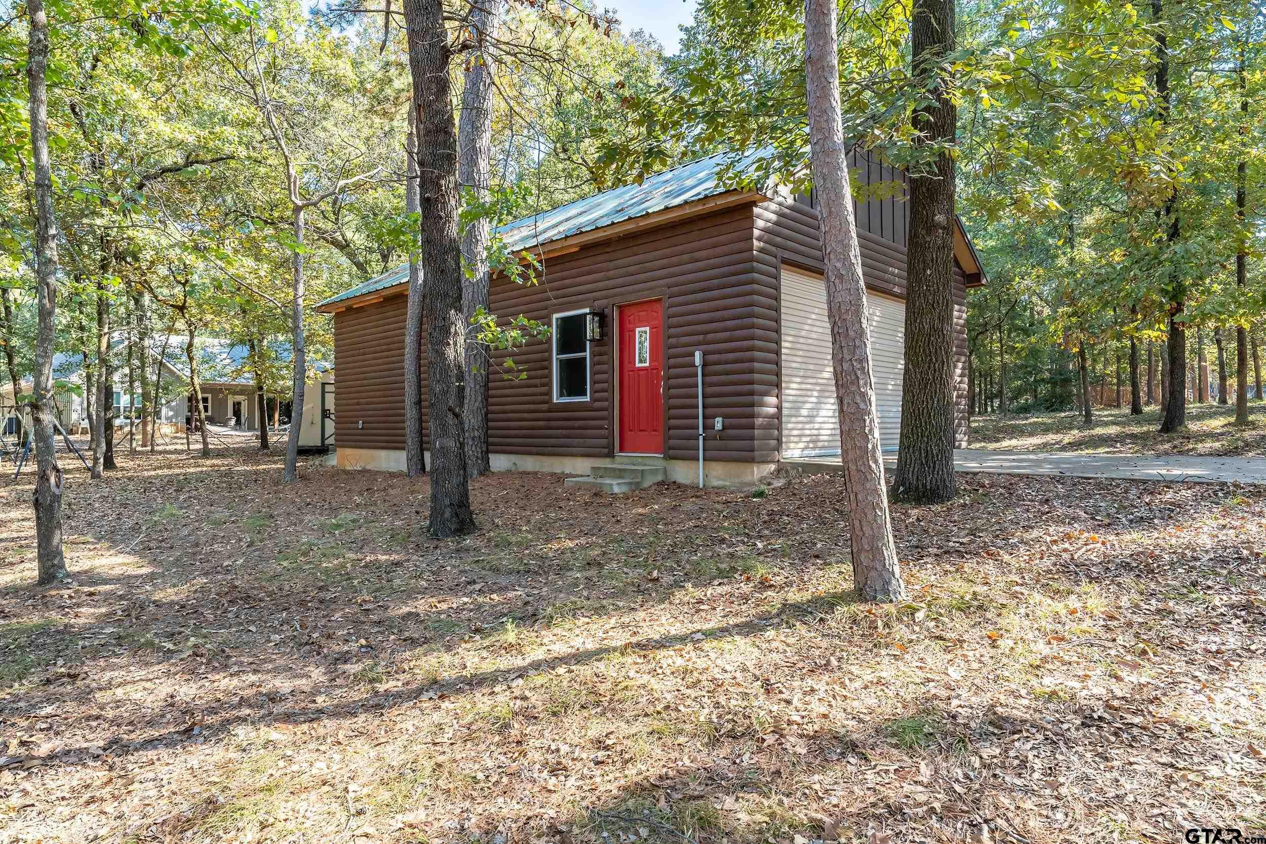 325 Laurel Lane Holly Lake Ranch, TX 75765 - Photo 27 of 34 a house is sitting in middle of forest