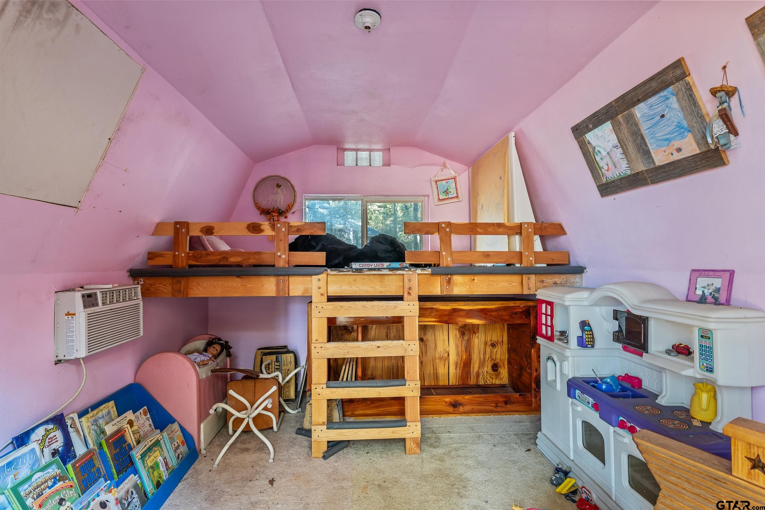 325 Laurel Lane Holly Lake Ranch, TX 75765 - Photo 31 of 34 a view of a bedroom with baby bed and toys
