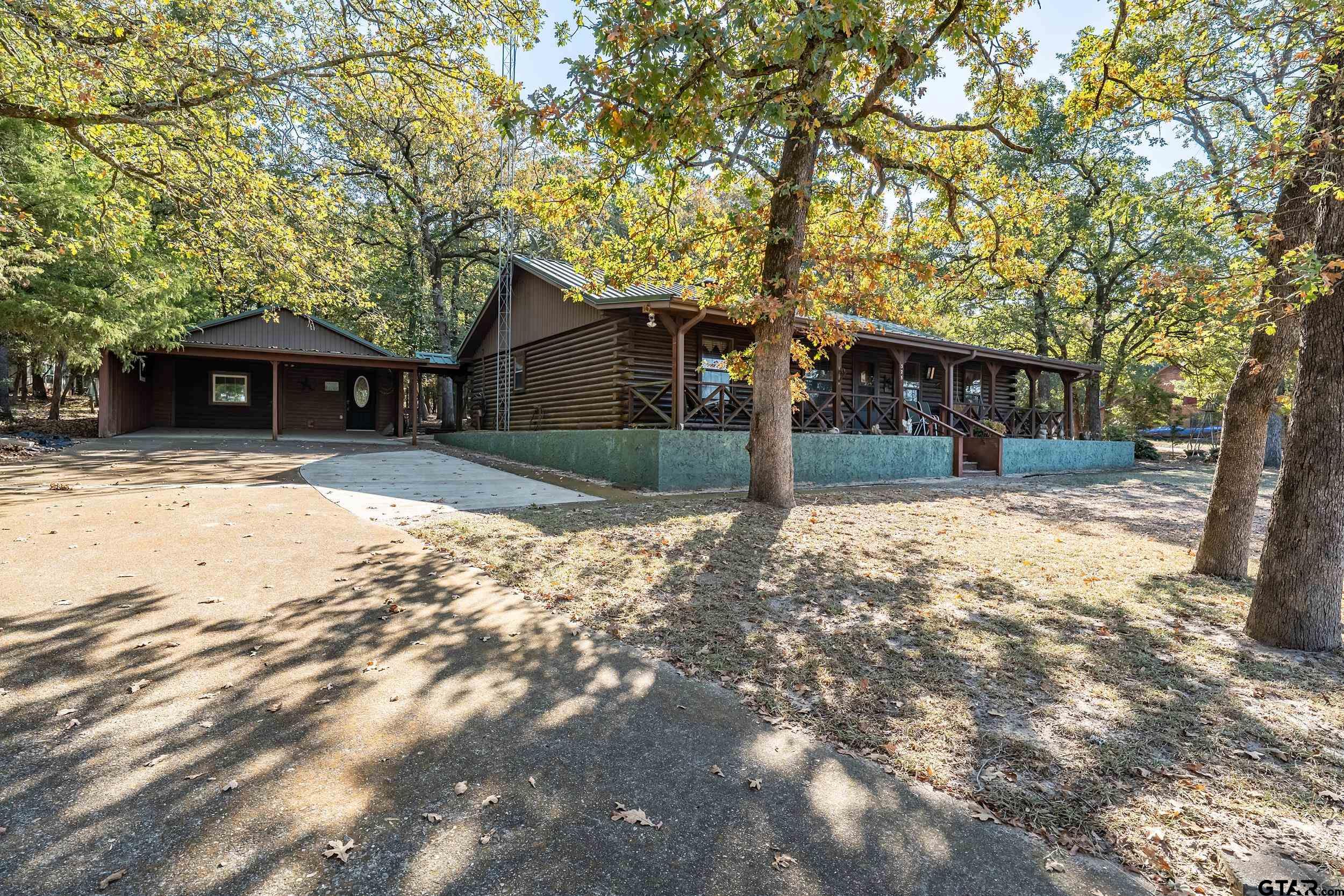 325 Laurel Lane Holly Lake Ranch, TX 75765 - Photo 32 of 34 a front view of a house with a yard and garage
