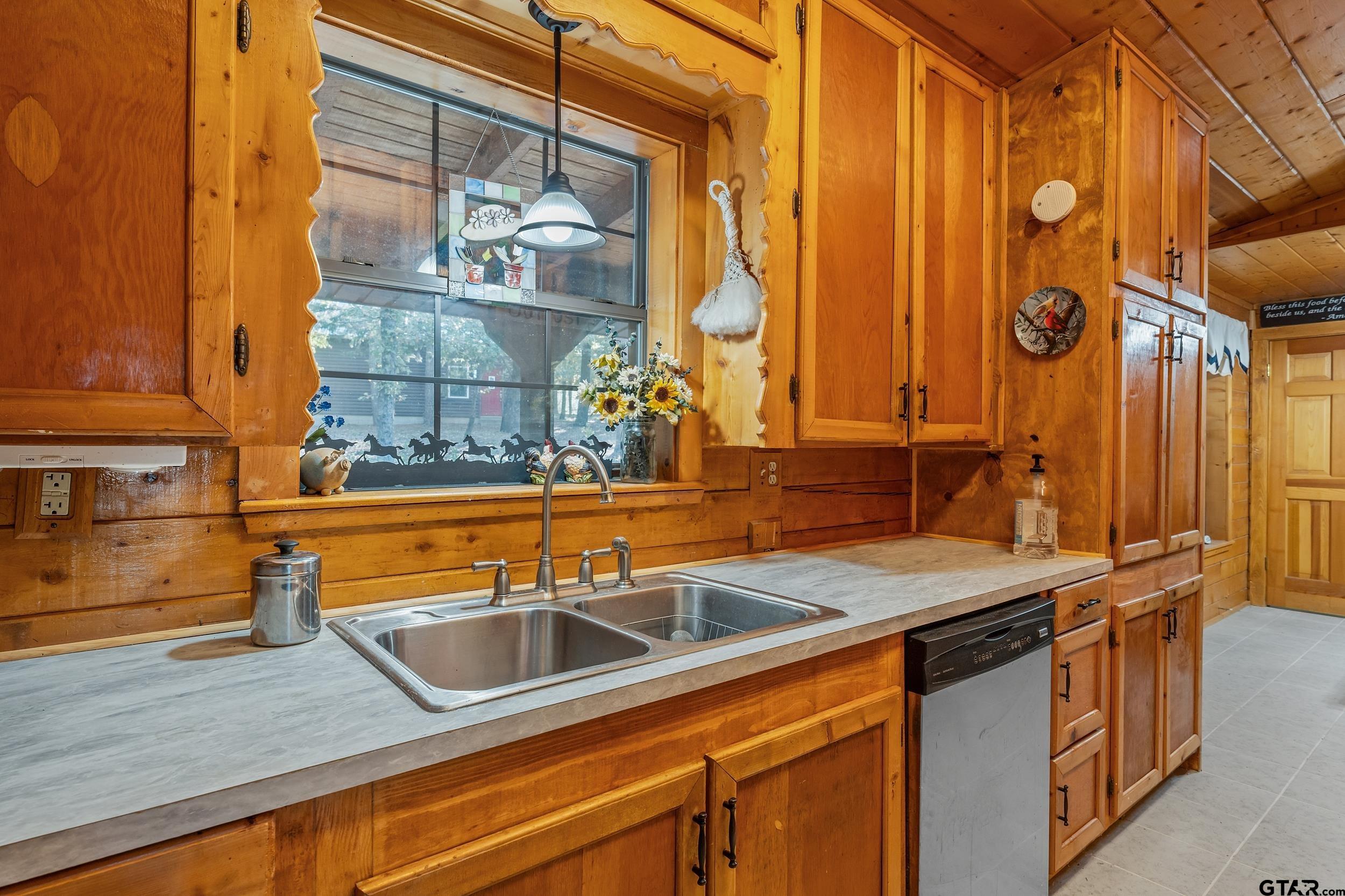 325 Laurel Lane Holly Lake Ranch, TX 75765 - Photo 6 of 34 a kitchen that has a sink and a stove with wooden floor