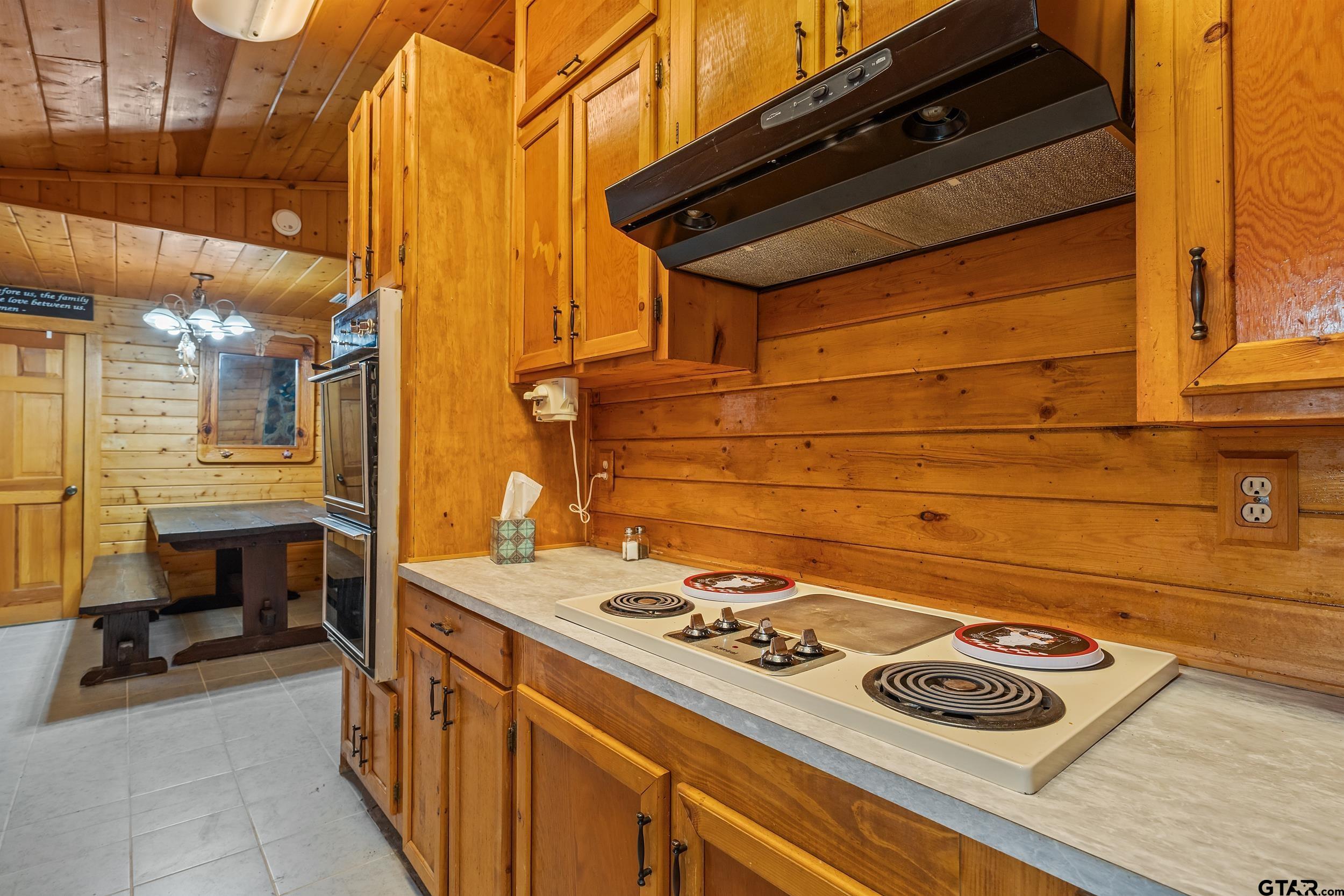 325 Laurel Lane Holly Lake Ranch, TX 75765 - Photo 7 of 34 a stove top oven sitting inside of a kitchen