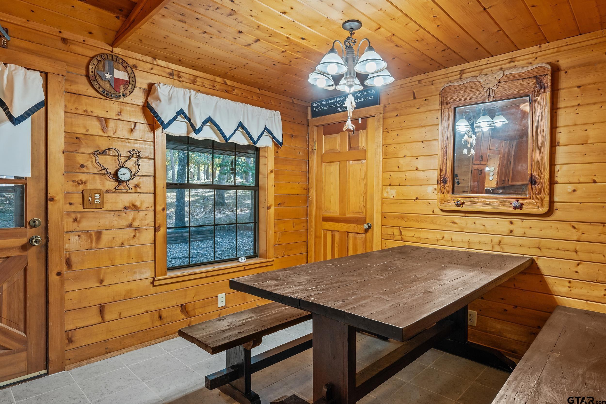 325 Laurel Lane Holly Lake Ranch, TX 75765 - Photo 9 of 34 a view of a dining room with furniture and chandelier