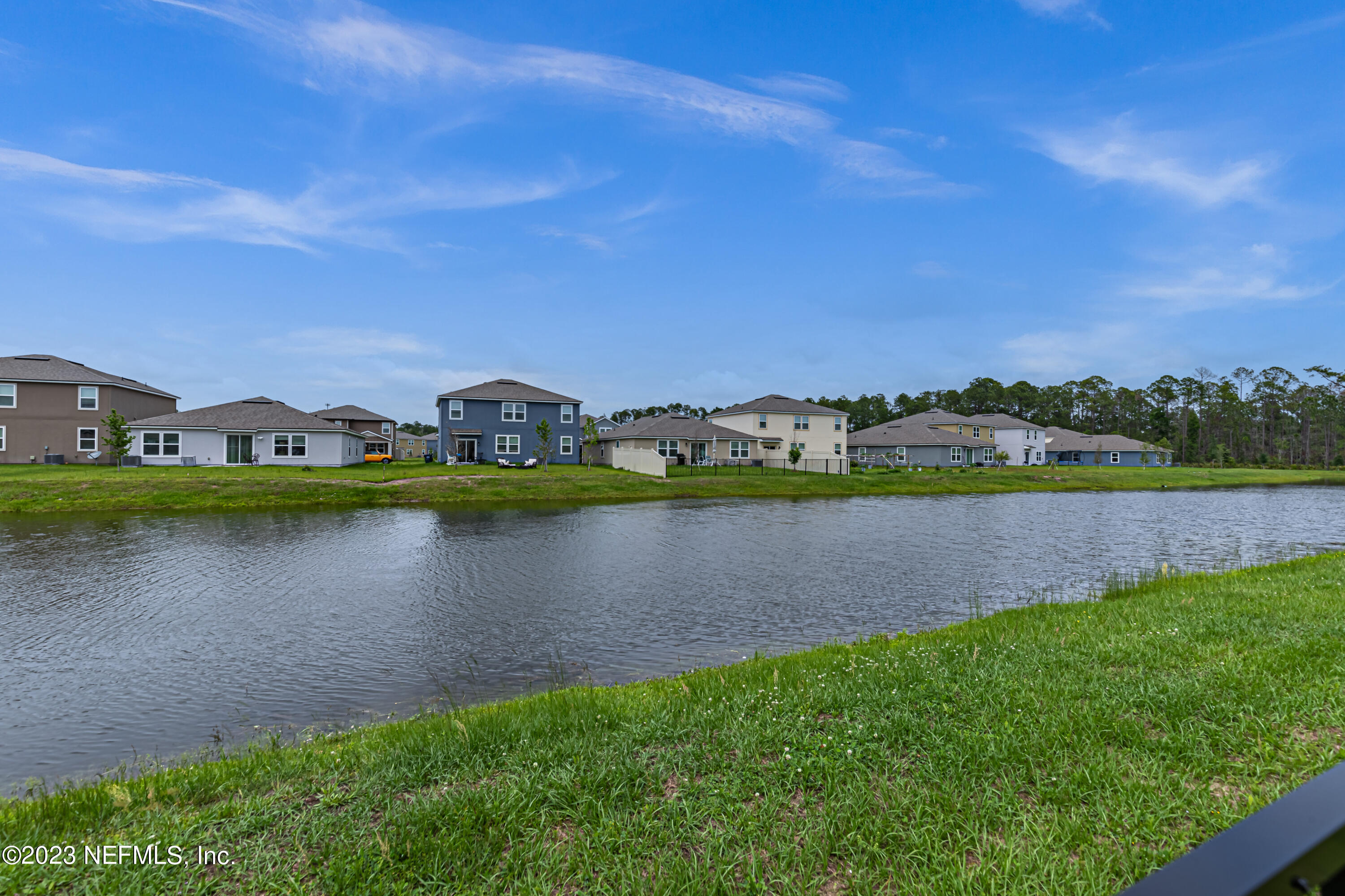 86205 Mainline Road Yulee, FL 32097 - Photo 18 of 19 a view of a lake with houses in the back
