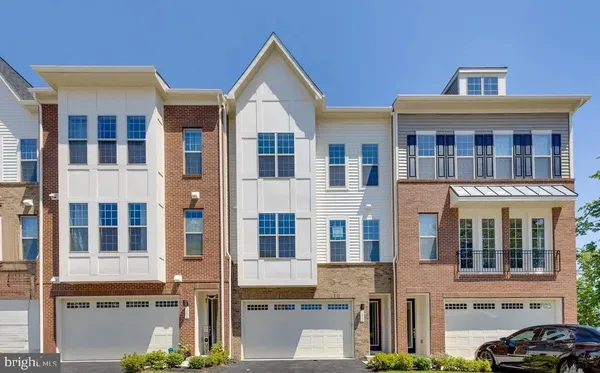 a front view of a residential apartment building with a yard