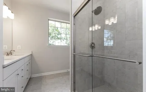 a bathroom with a shower and sink
