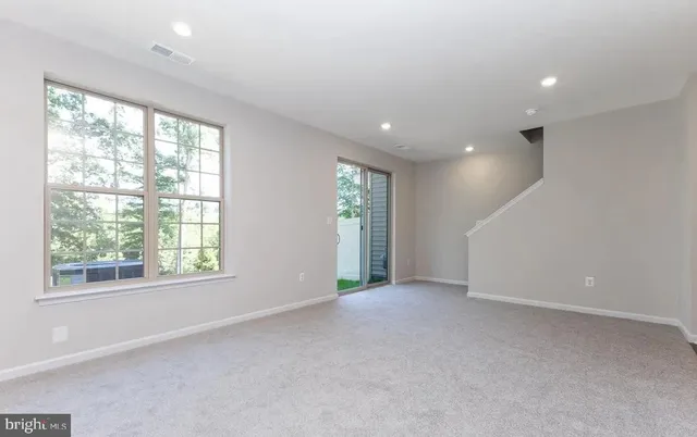an empty room with windows and closet