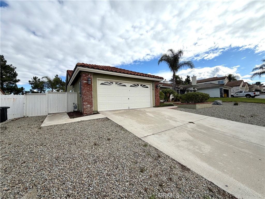 44836 Marge Place Temecula, CA 92592 - Photo 3 of 35 a backyard of a house with a yard and garage