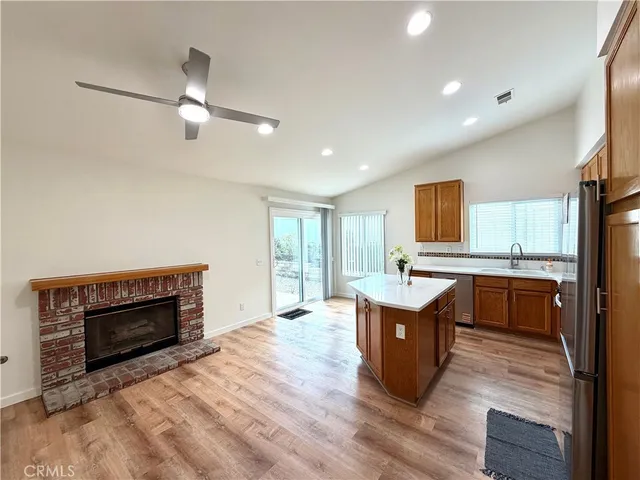 a living room with furniture a fireplace and a window