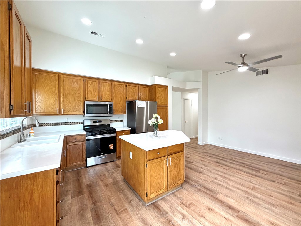 44836 Marge Place Temecula, CA 92592 - Photo 10 of 35 a kitchen with stainless steel appliances granite countertop a sink stove and refrigerator