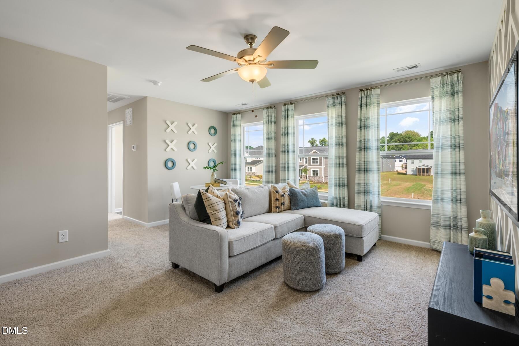167 Siebold Street Garner, NC 27529 - Photo 32 of 42 a living room with furniture and a large window with garden view