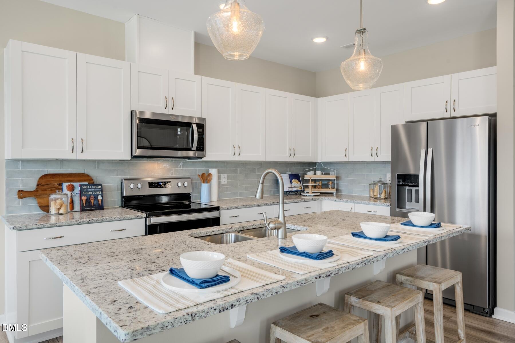 167 Siebold Street Garner, NC 27529 - Photo 33 of 46 a kitchen with sink a refrigerator and chairs