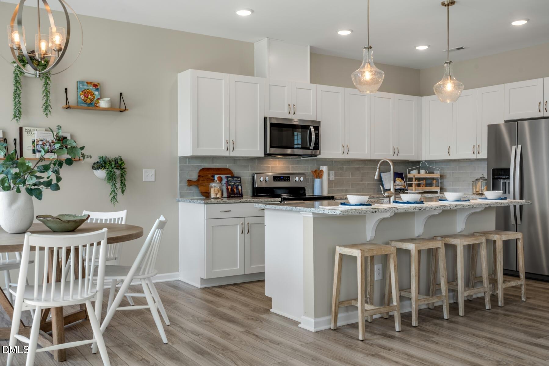 167 Siebold Street Garner, NC 27529 - Photo 34 of 46 a kitchen with granite countertop white cabinets and stainless steel appliances
