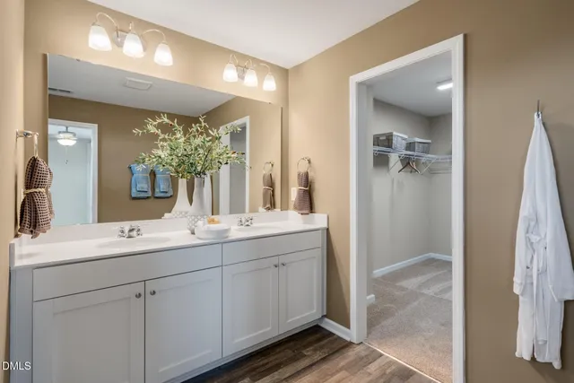 a bathroom with a double vanity sink and a mirror