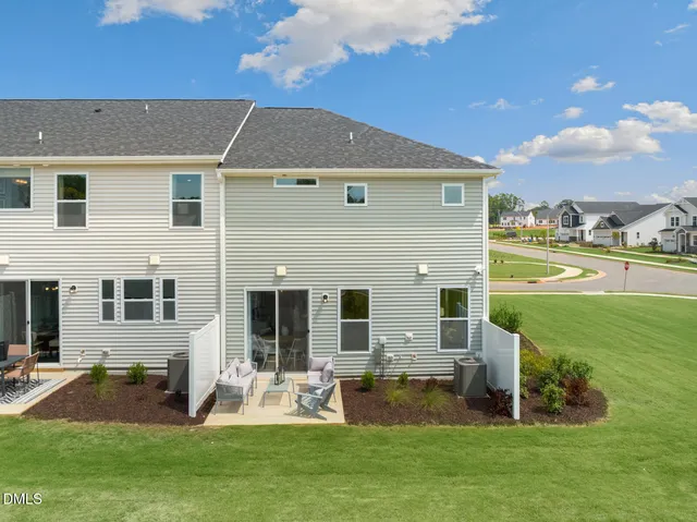 a front view of house with yard and outdoor seating