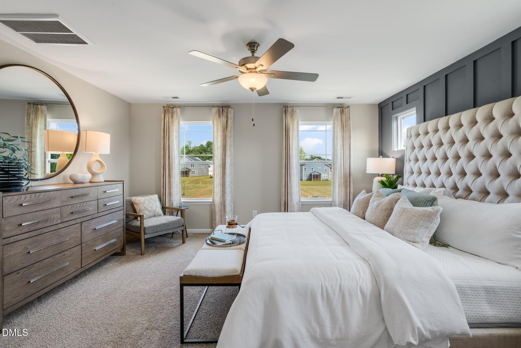 167 Siebold Street Garner, NC 27529 - Photo 42 of 46 a bedroom with a large bed and a chandelier