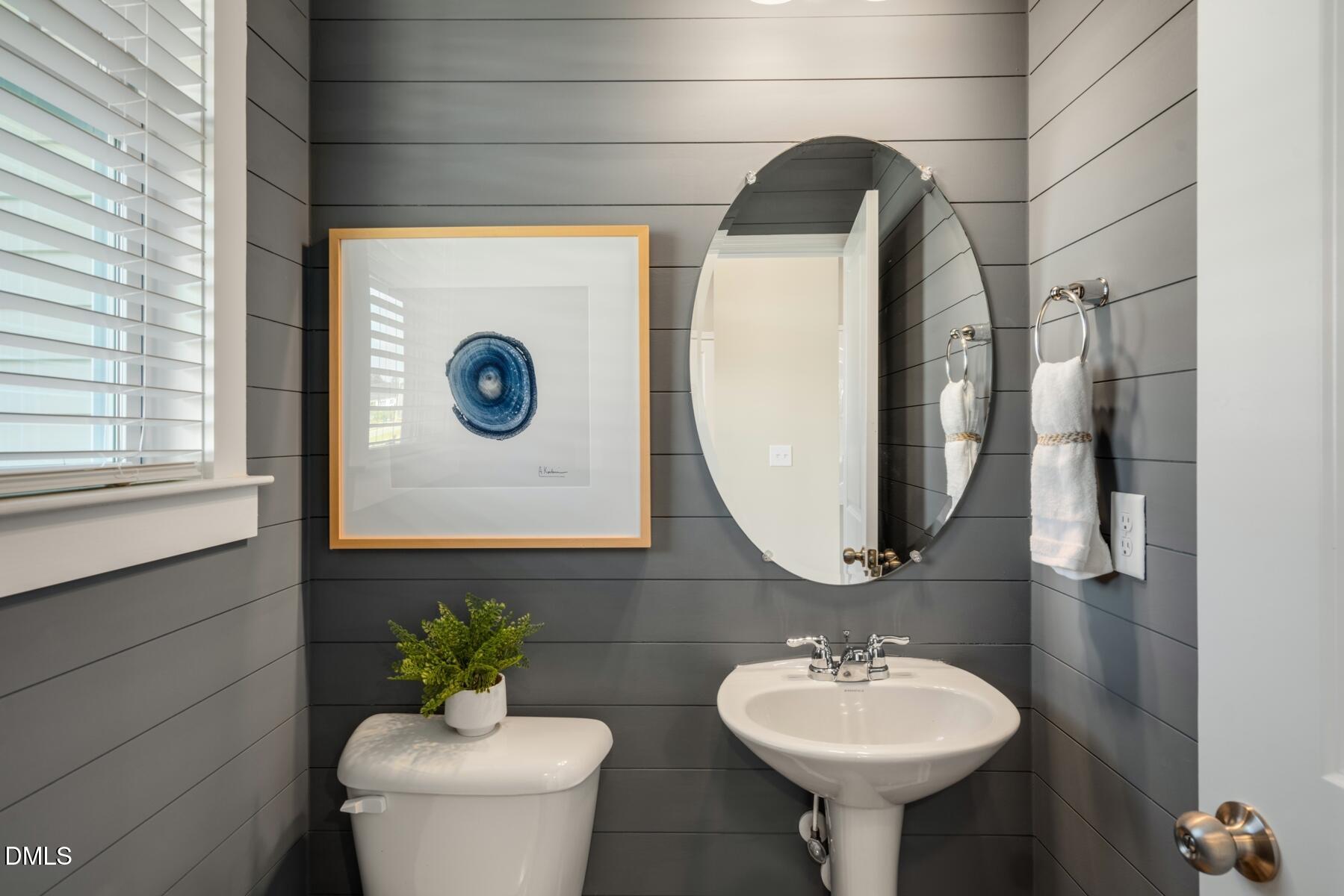 167 Siebold Street Garner, NC 27529 - Photo 42 of 42 a bathroom with a toilet sink and mirror