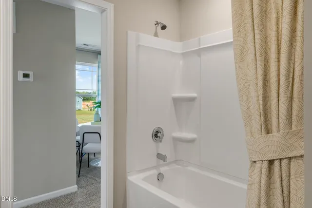 a bathroom with a tub and shower