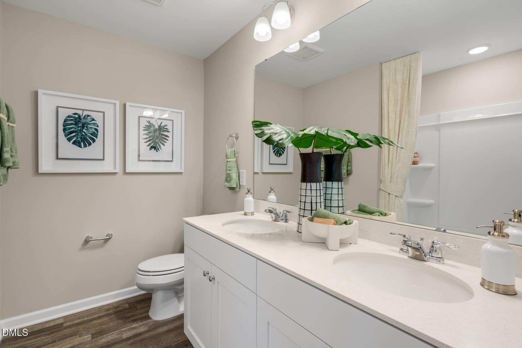 167 Siebold Street Garner, NC 27529 - Photo 10 of 46 a bathroom with a toilet sink and mirror