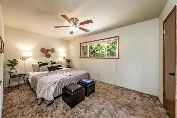 a bed room with a bed and a chandelier
