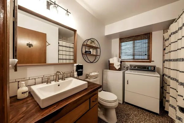 a bathroom with a toilet sink and mirror
